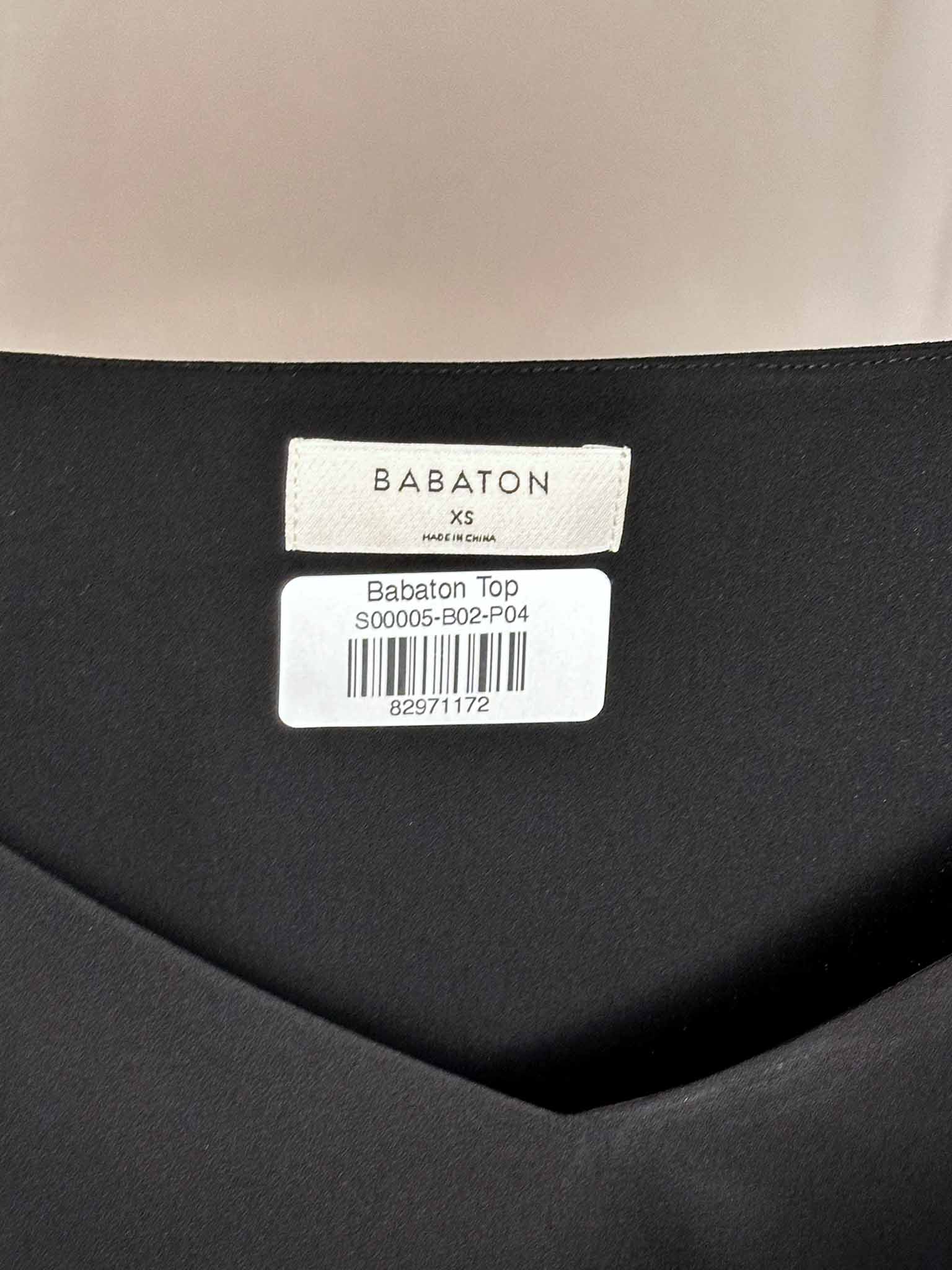 Babaton label on a black garment with a beige background