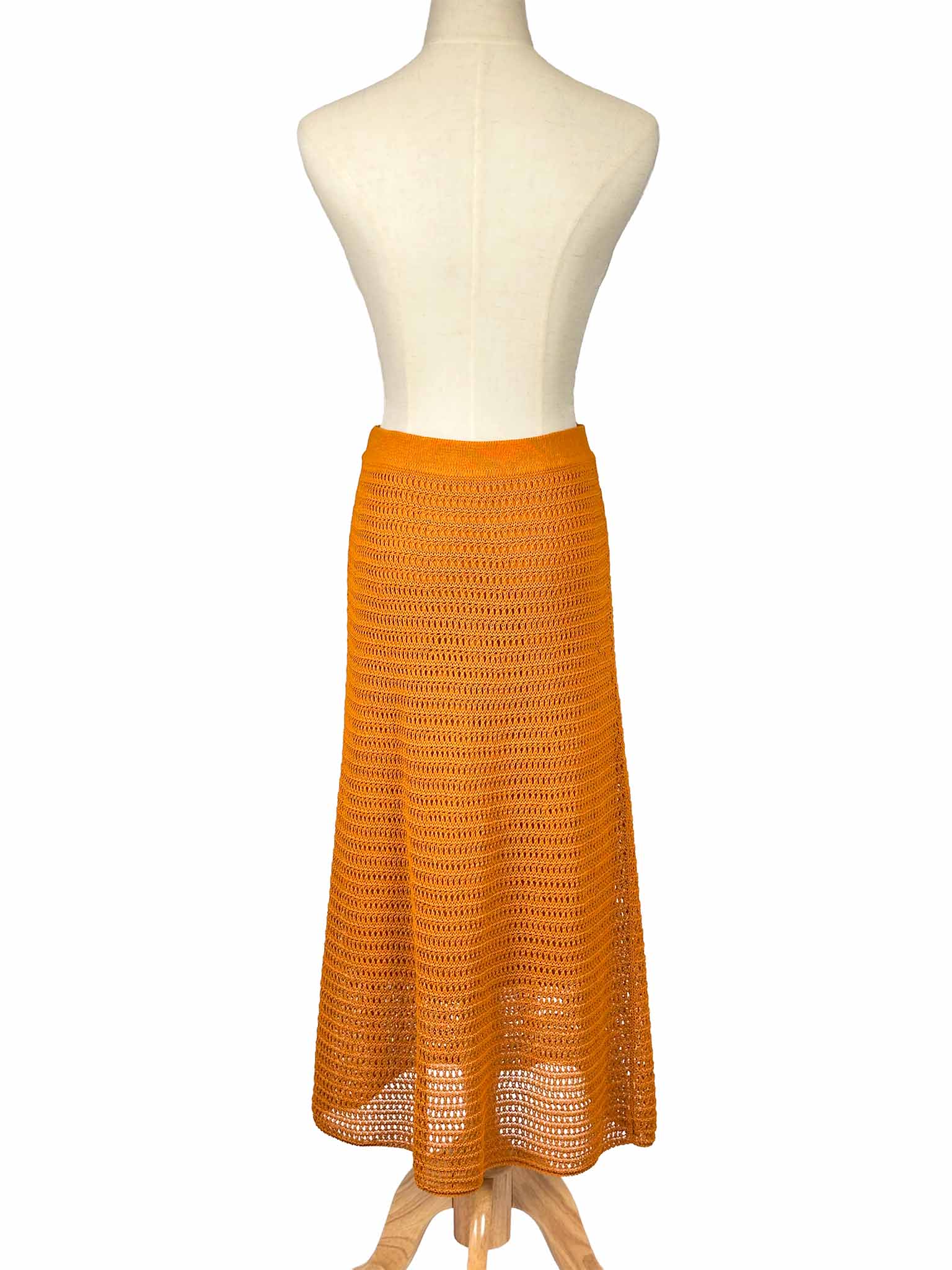 Vince orange crochet skirt on a mannequin against a white background