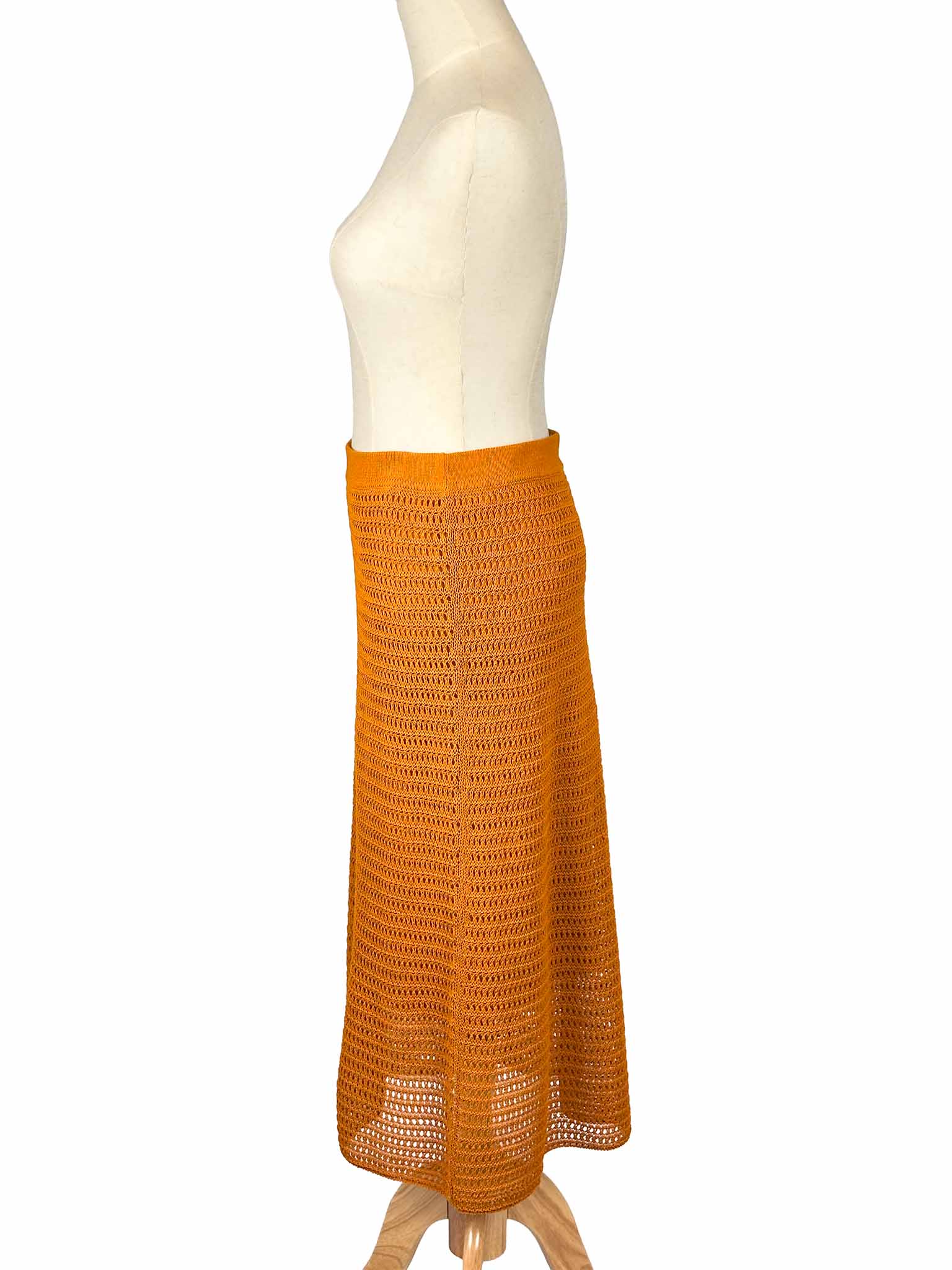 Vince orange crochet skirt on a mannequin against a white background