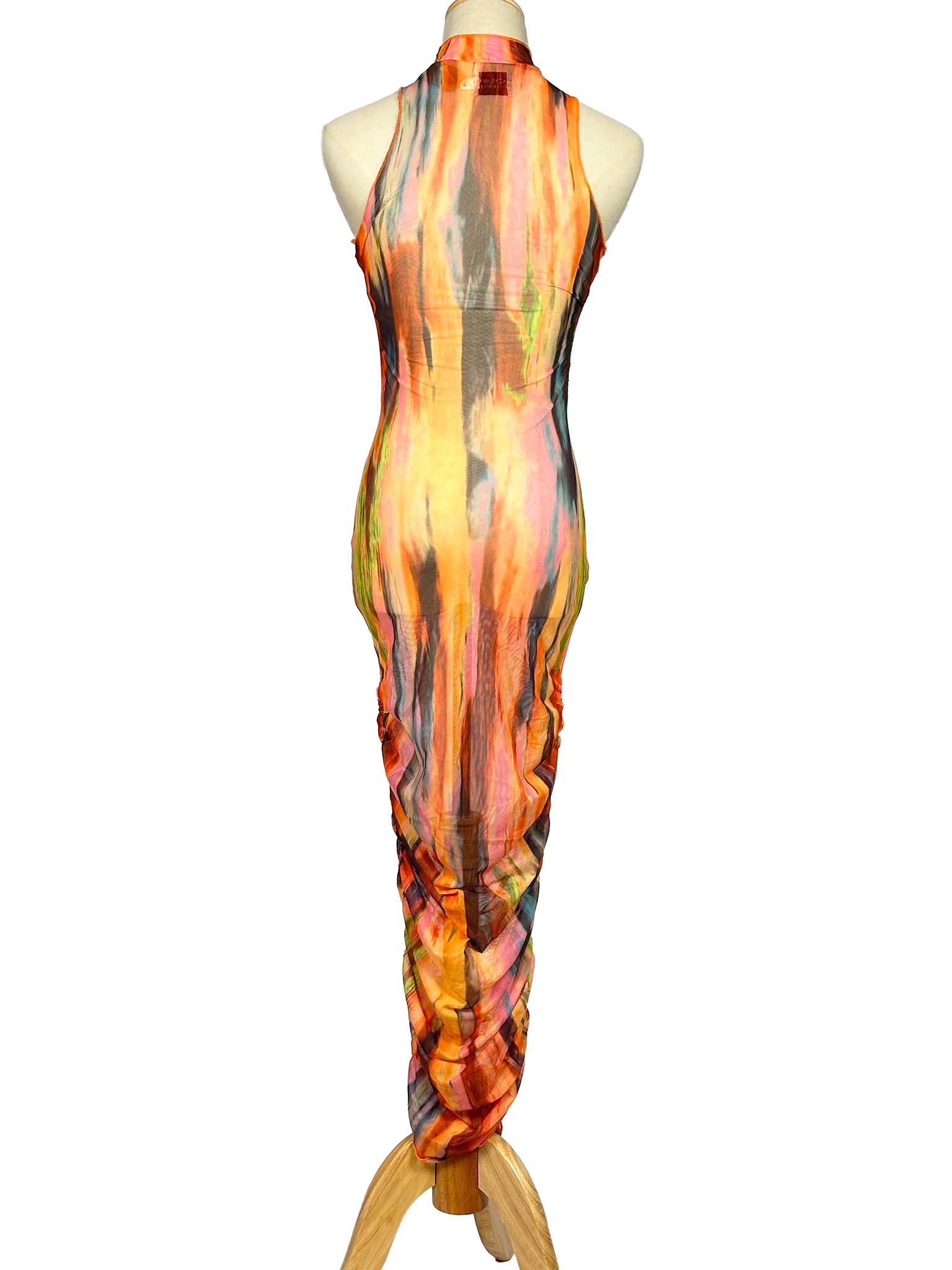 Mannequin wearing a colorful SNDYS. dress with abstract patterns on a white background
