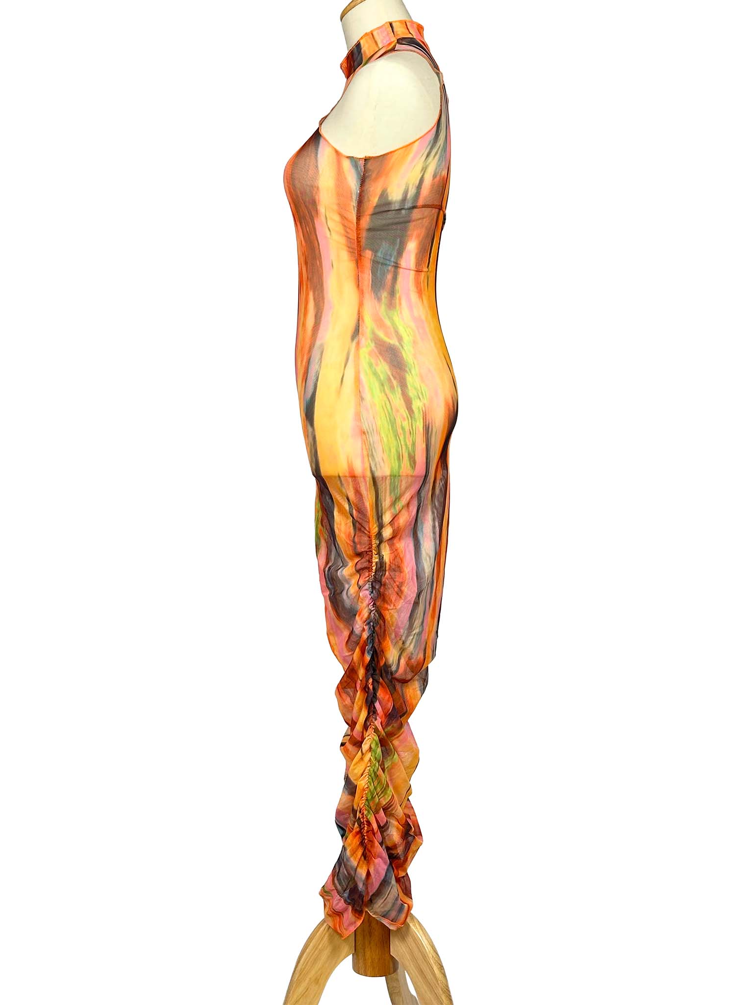 Mannequin wearing a colorful SNDYS. dress with abstract patterns on a white background