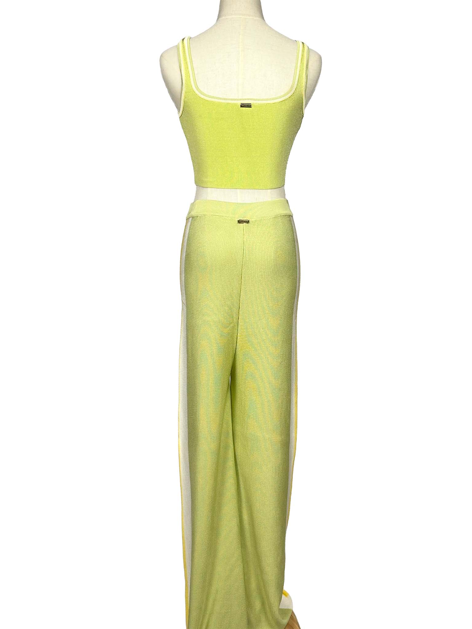 Mannequin wearing a light green Moeva top and pants set on a white background