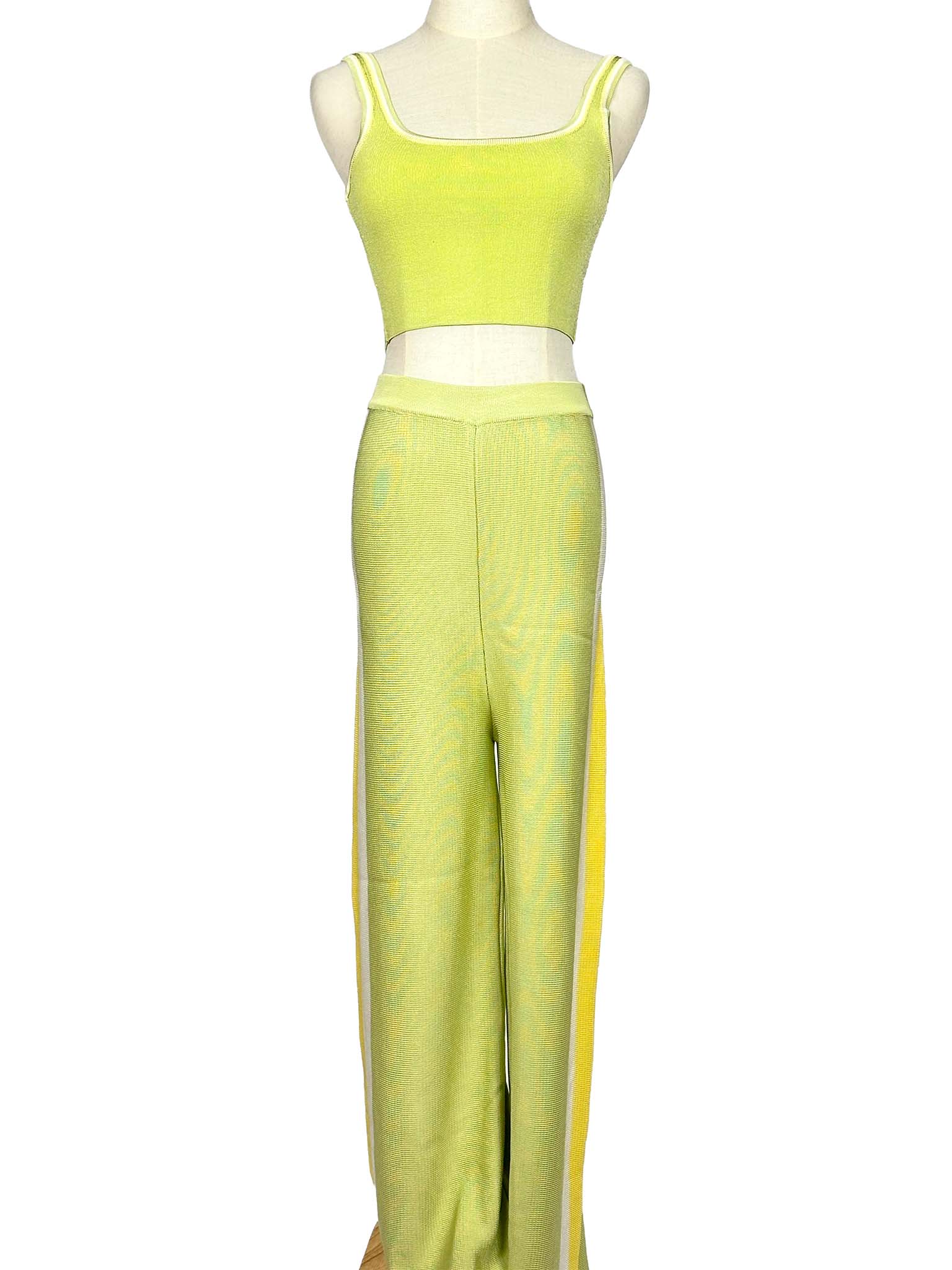 Mannequin wearing a light green Moeva top and pants set on a white background