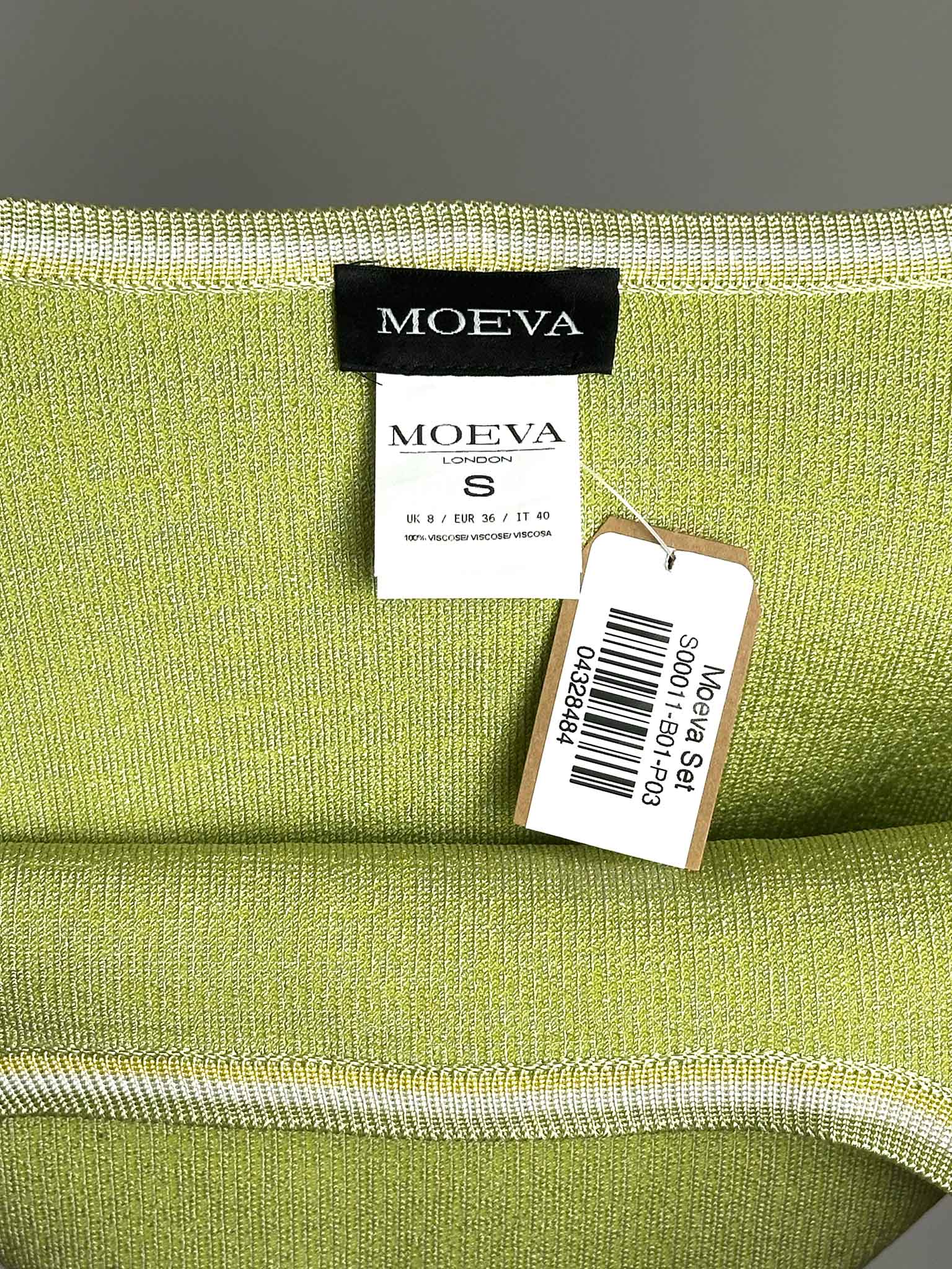 Green fabric top with MOEVA label and S size tag on a gray background