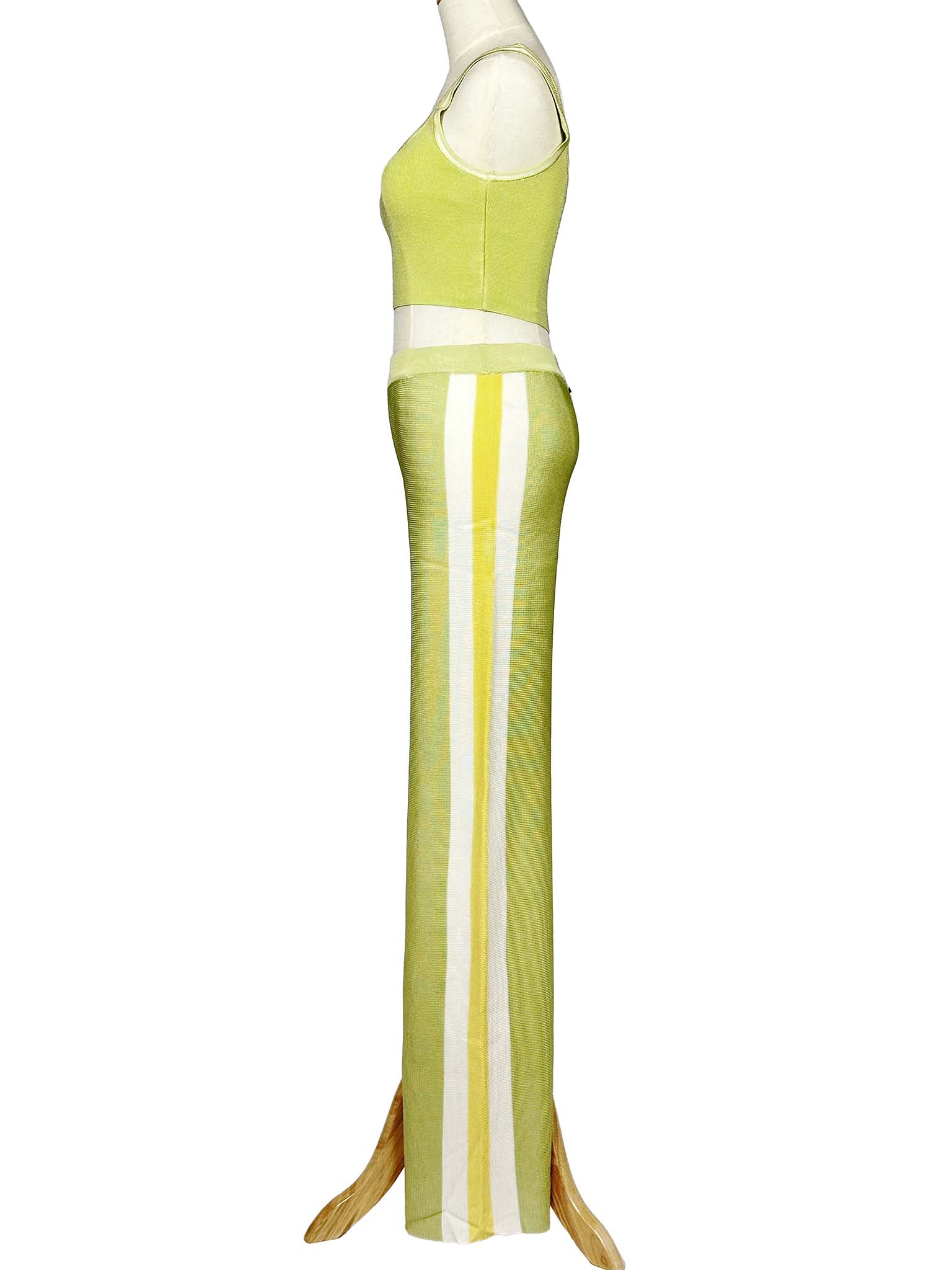 Side view of a mannequin wearing a light green Moeva top and pants set on a white background
