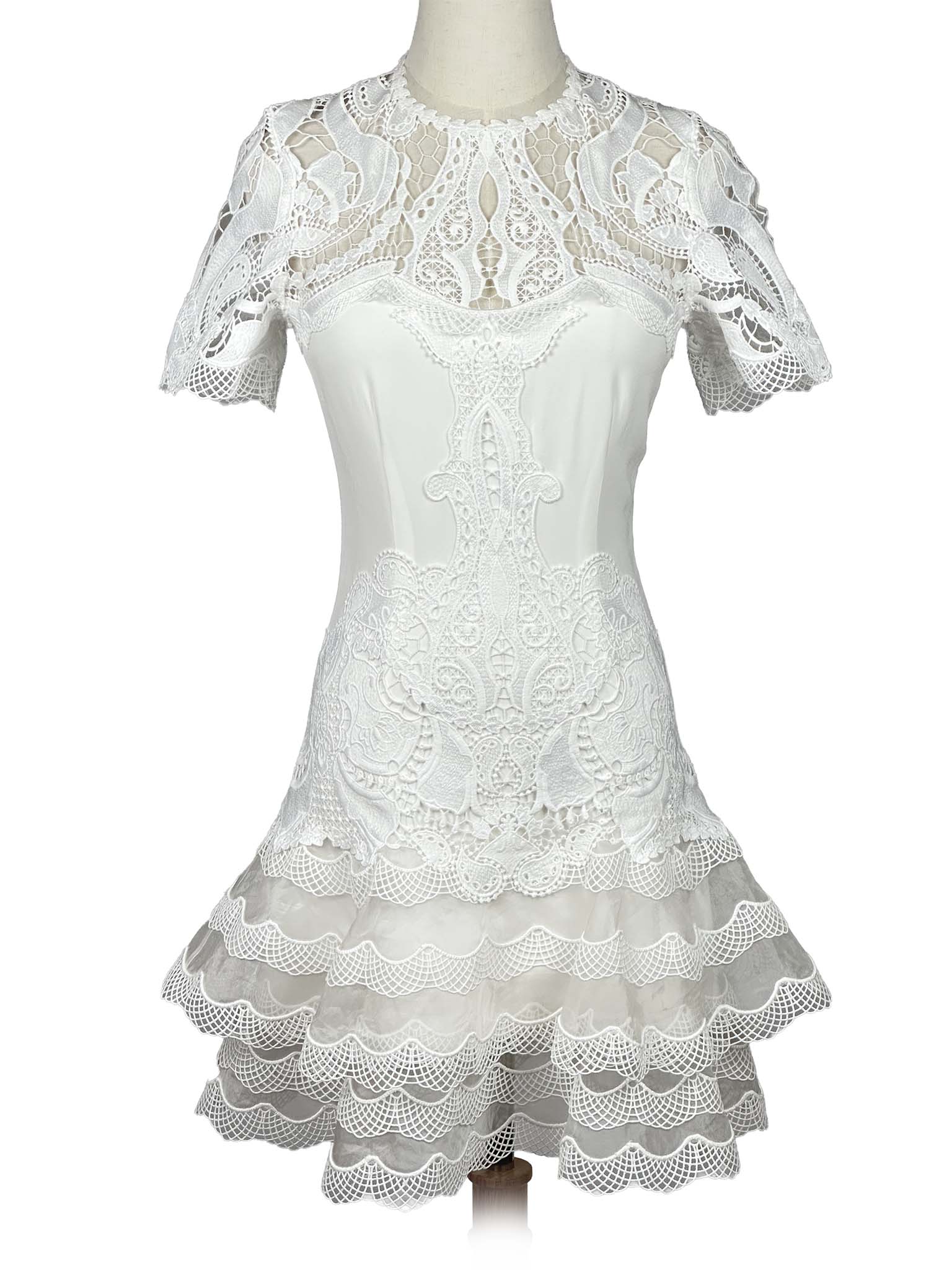 White lace Jonathan Simkhai dress on a mannequin against a white background