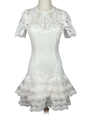 White lace Jonathan Simkhai dress on a mannequin against a white background