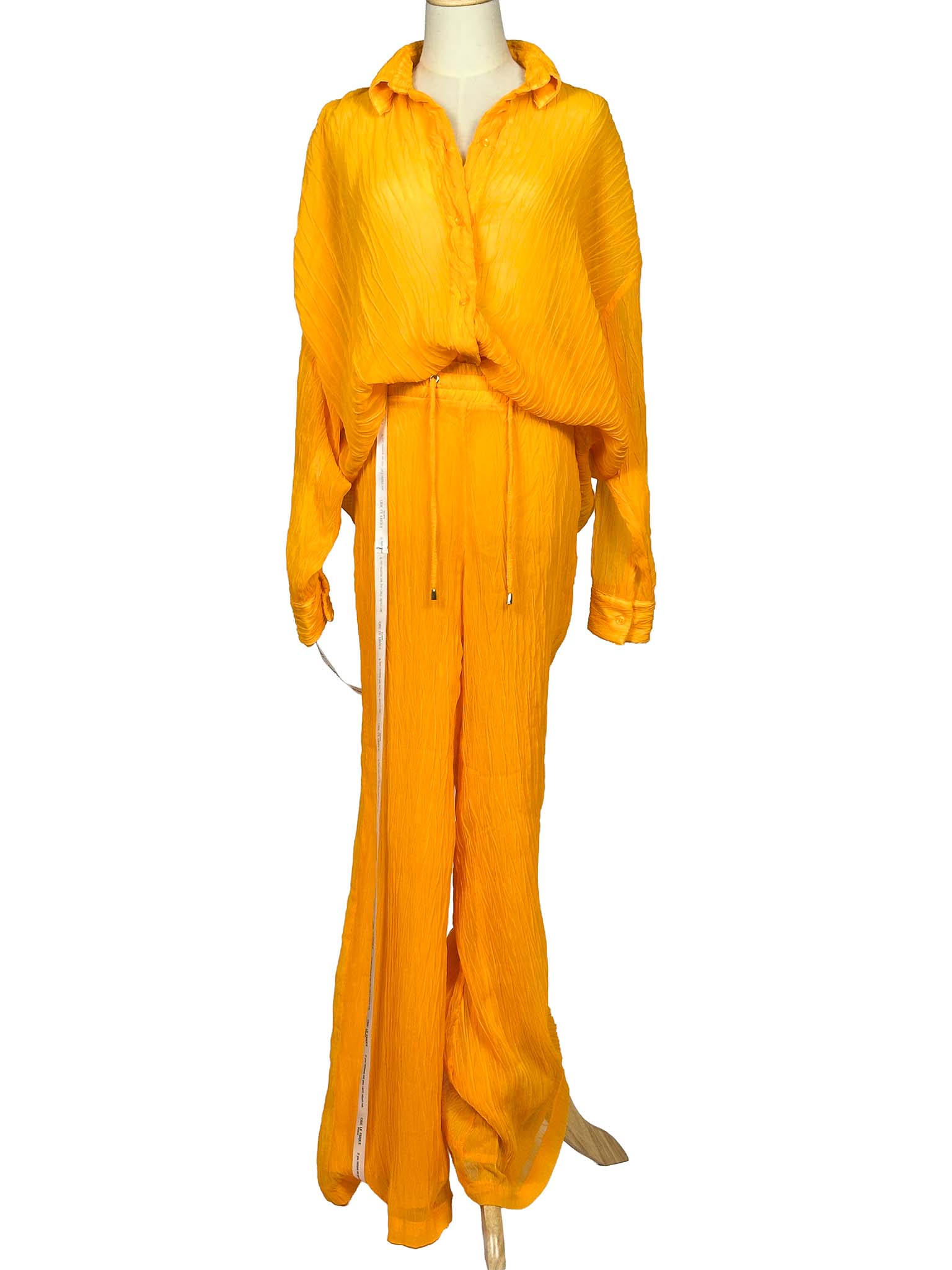 Orange Chic Le Frique top and pants set on a mannequin against a white background