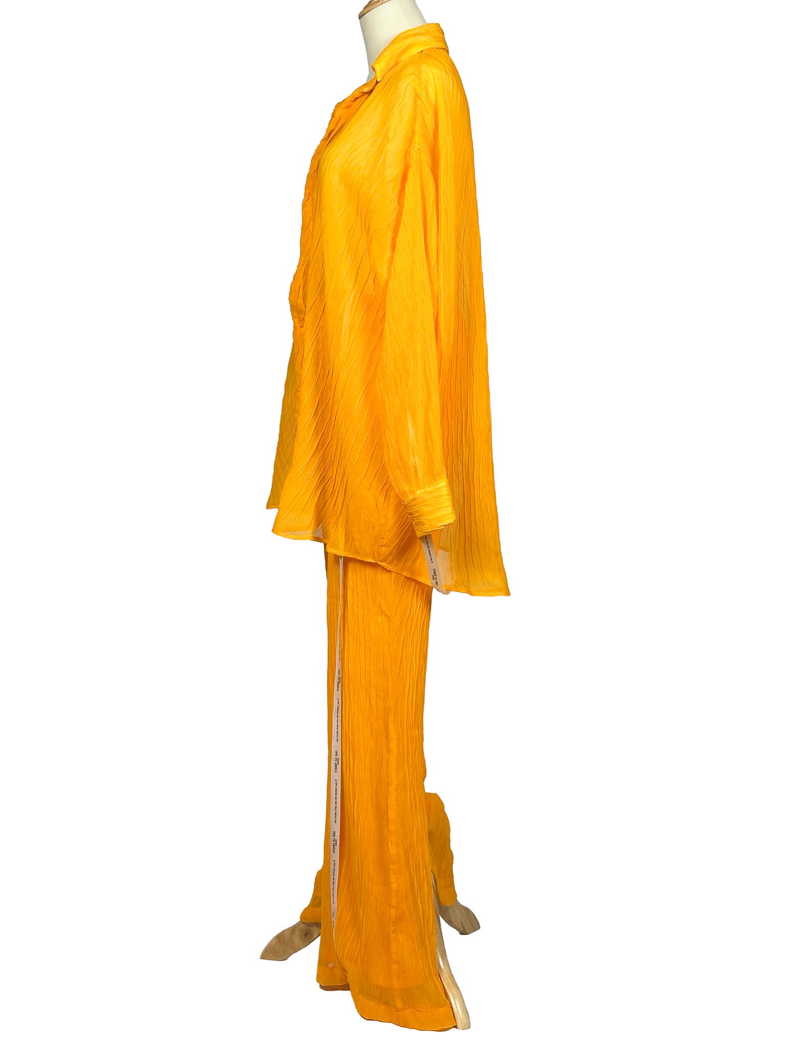 Orange Chic Le Frique top and pants set on a mannequin against a white background