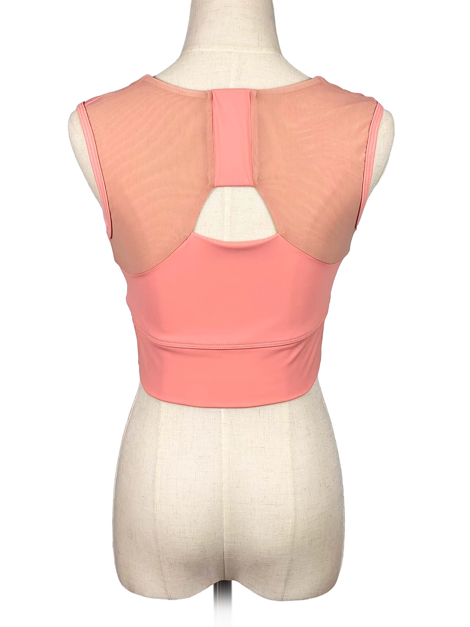 Forme coral sports top on a mannequin with a white background
