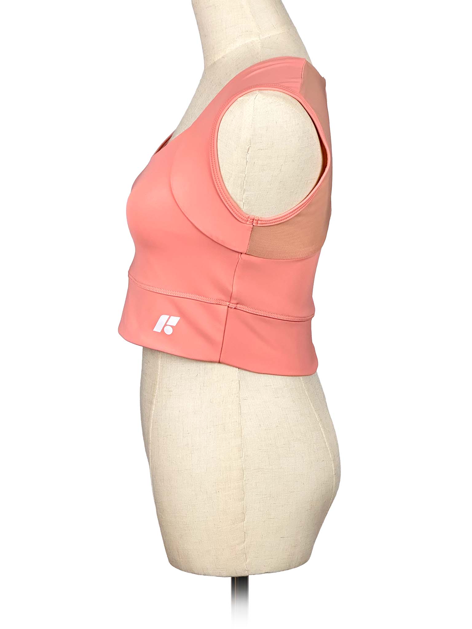 Forme coral sports top on a mannequin with a white background