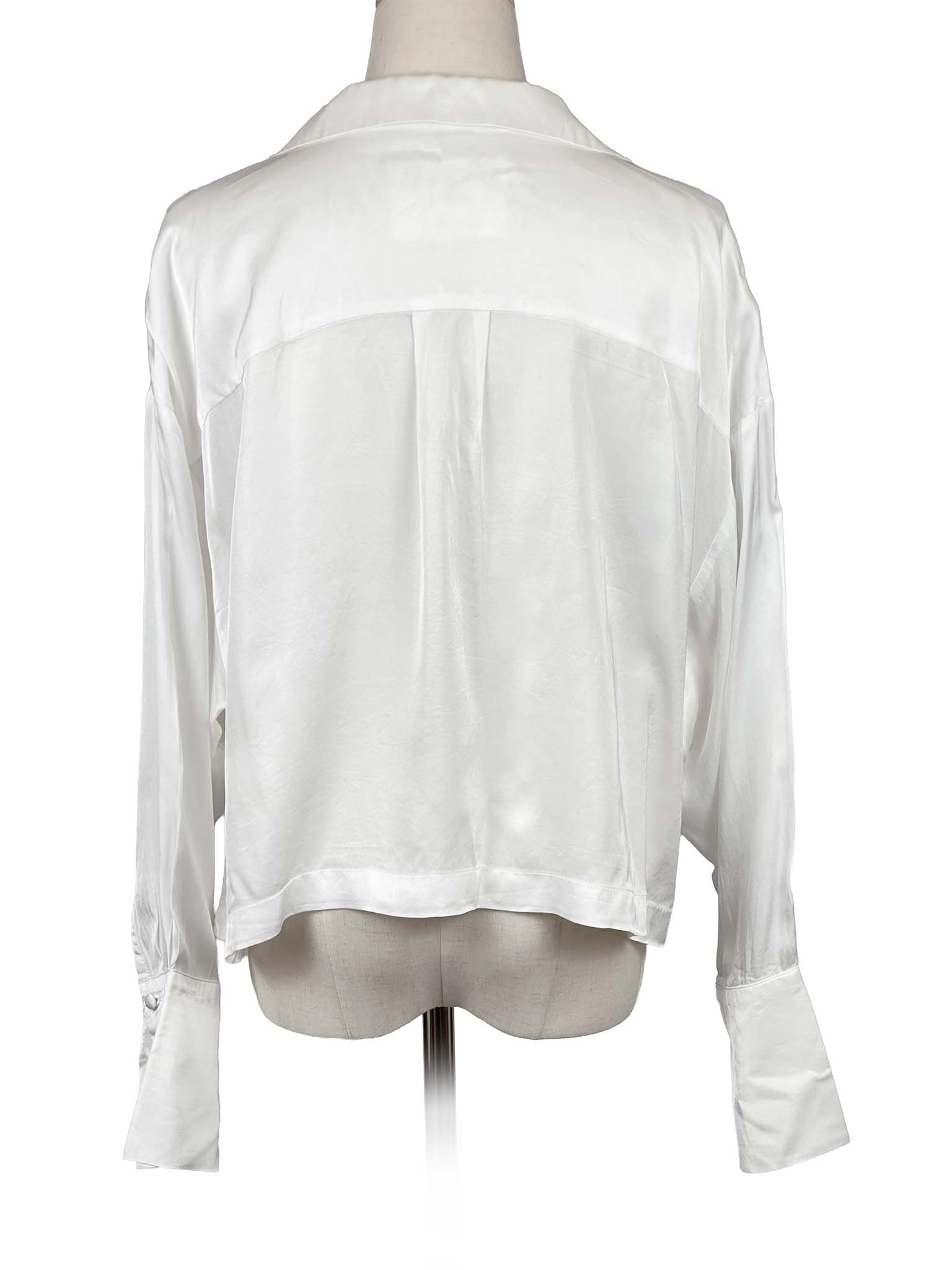 Anthropologie white blouse on a mannequin against a white background