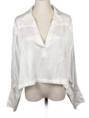 Anthropologie white sheer blouse on a mannequin against a white background