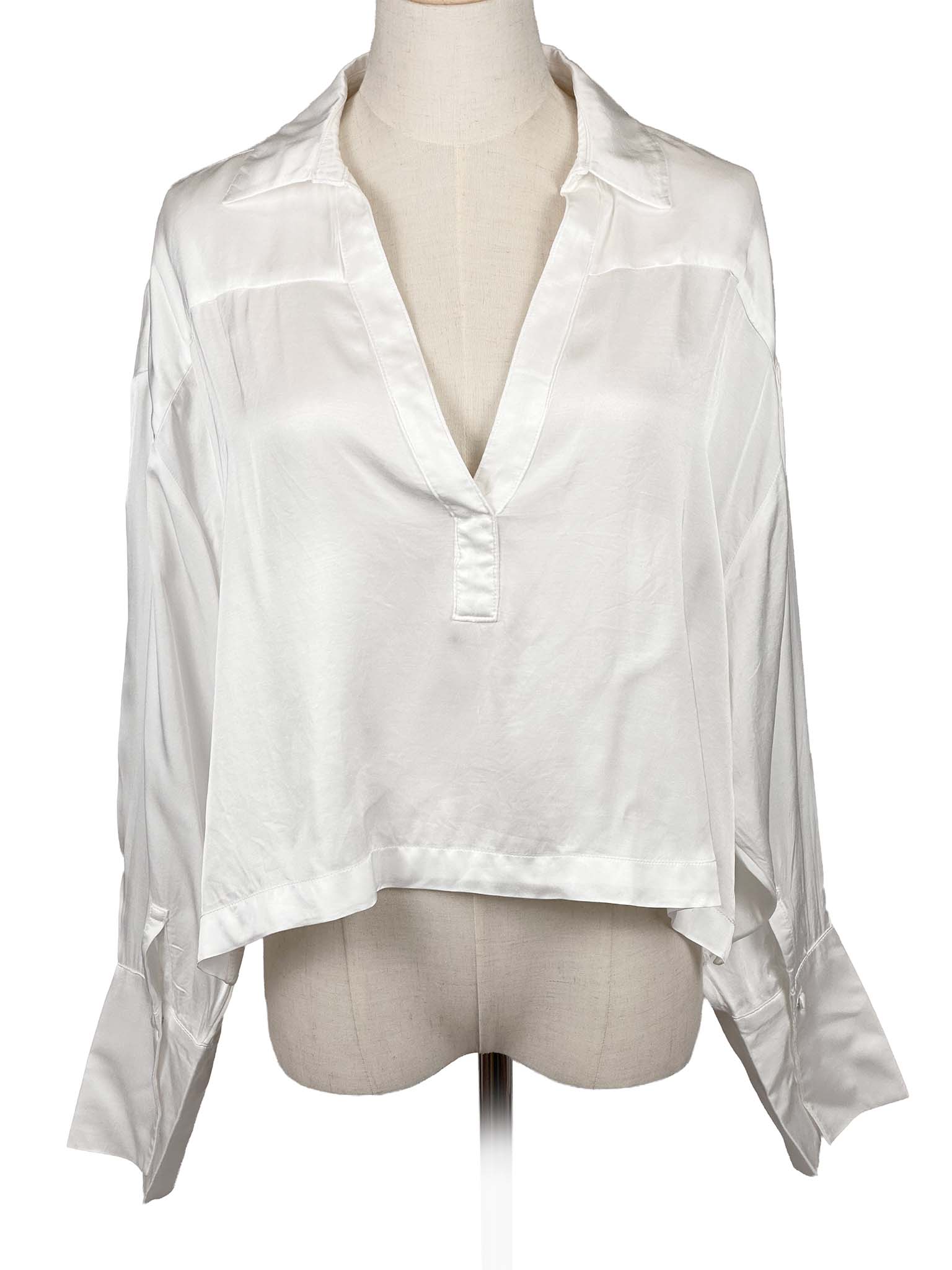 Anthropologie white sheer blouse on a mannequin against a white background
