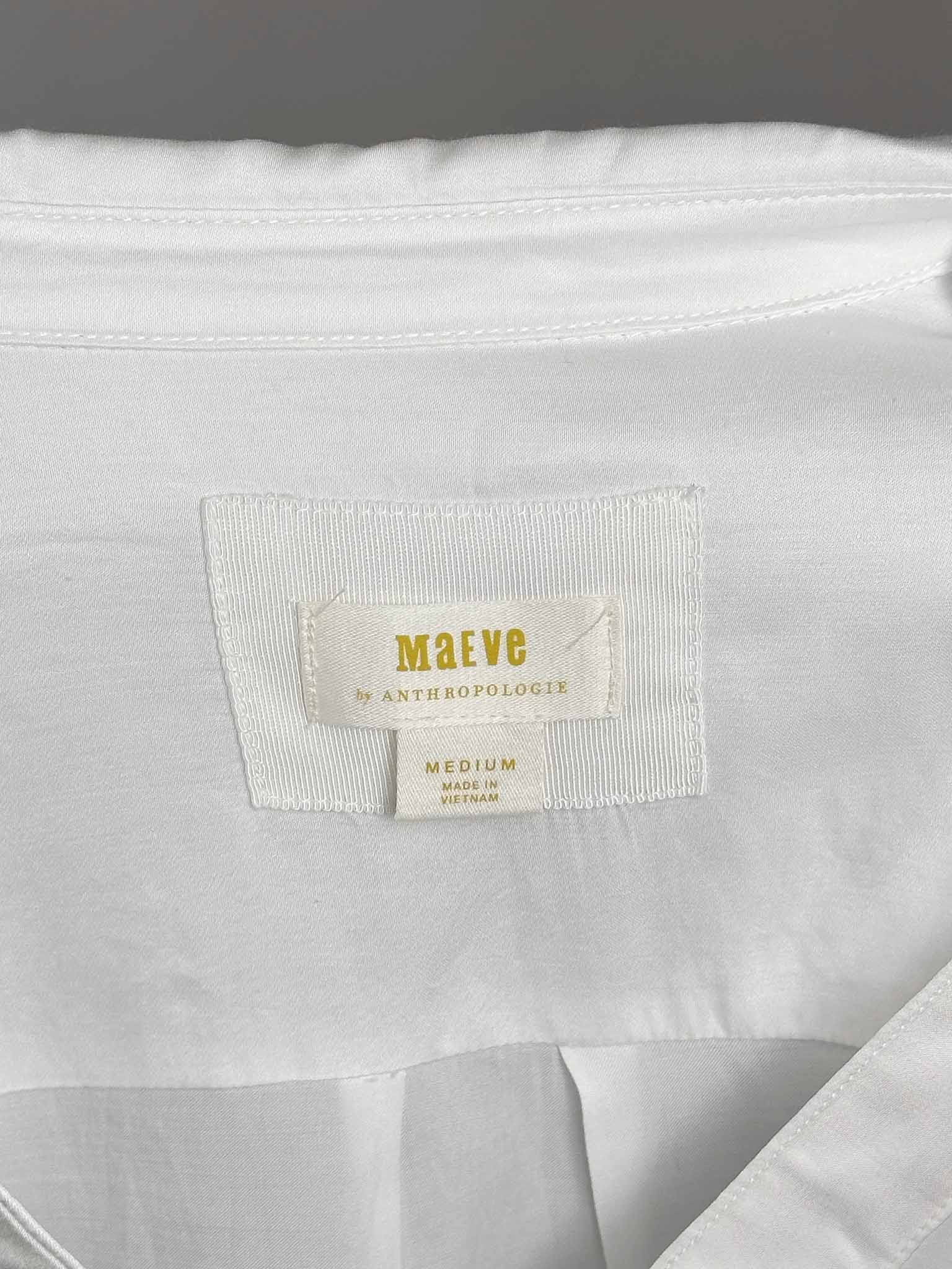 White shirt with a 'maéve' label on a gray background