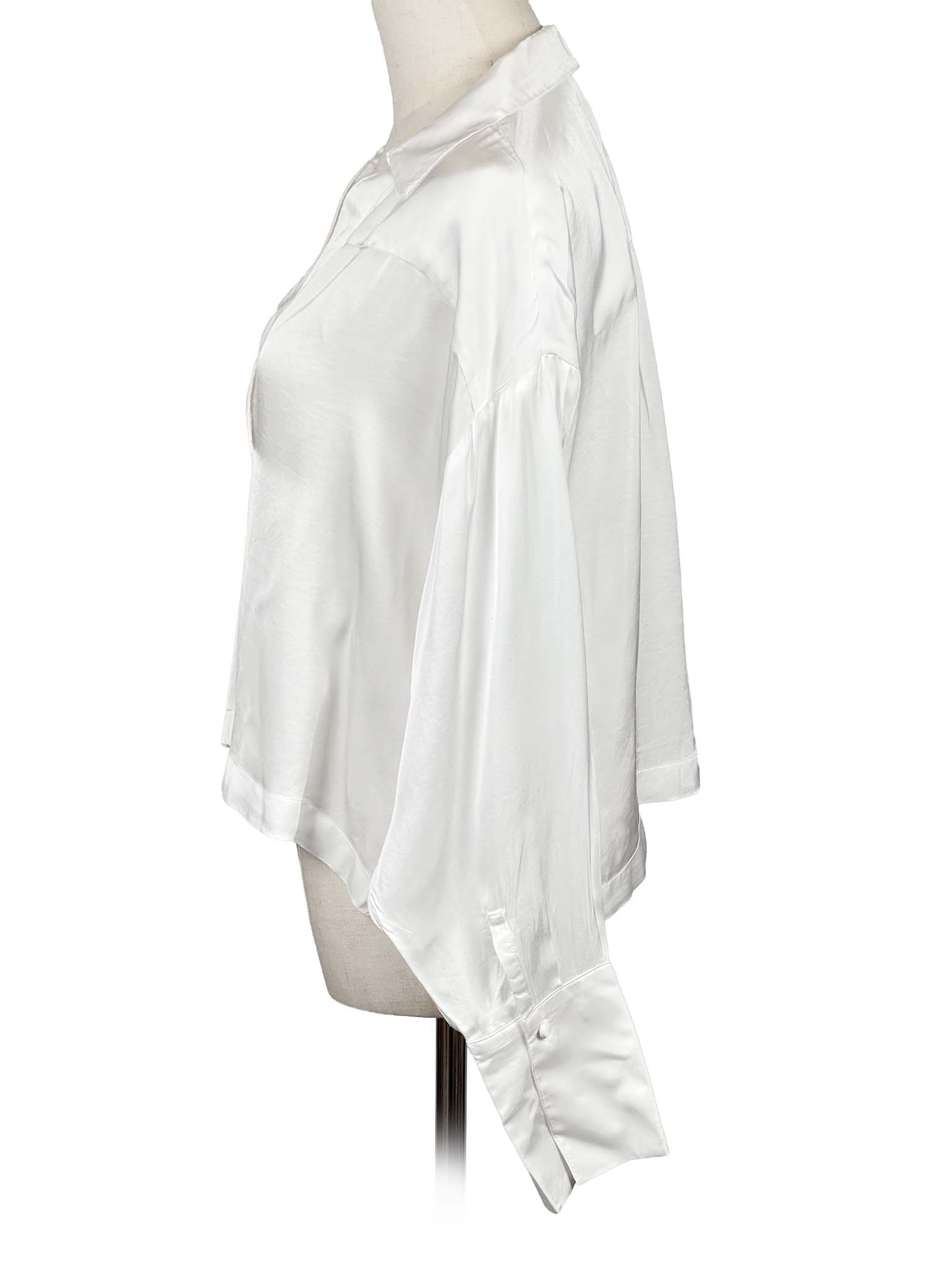 Anthropologie white blouse on a mannequin against a white background