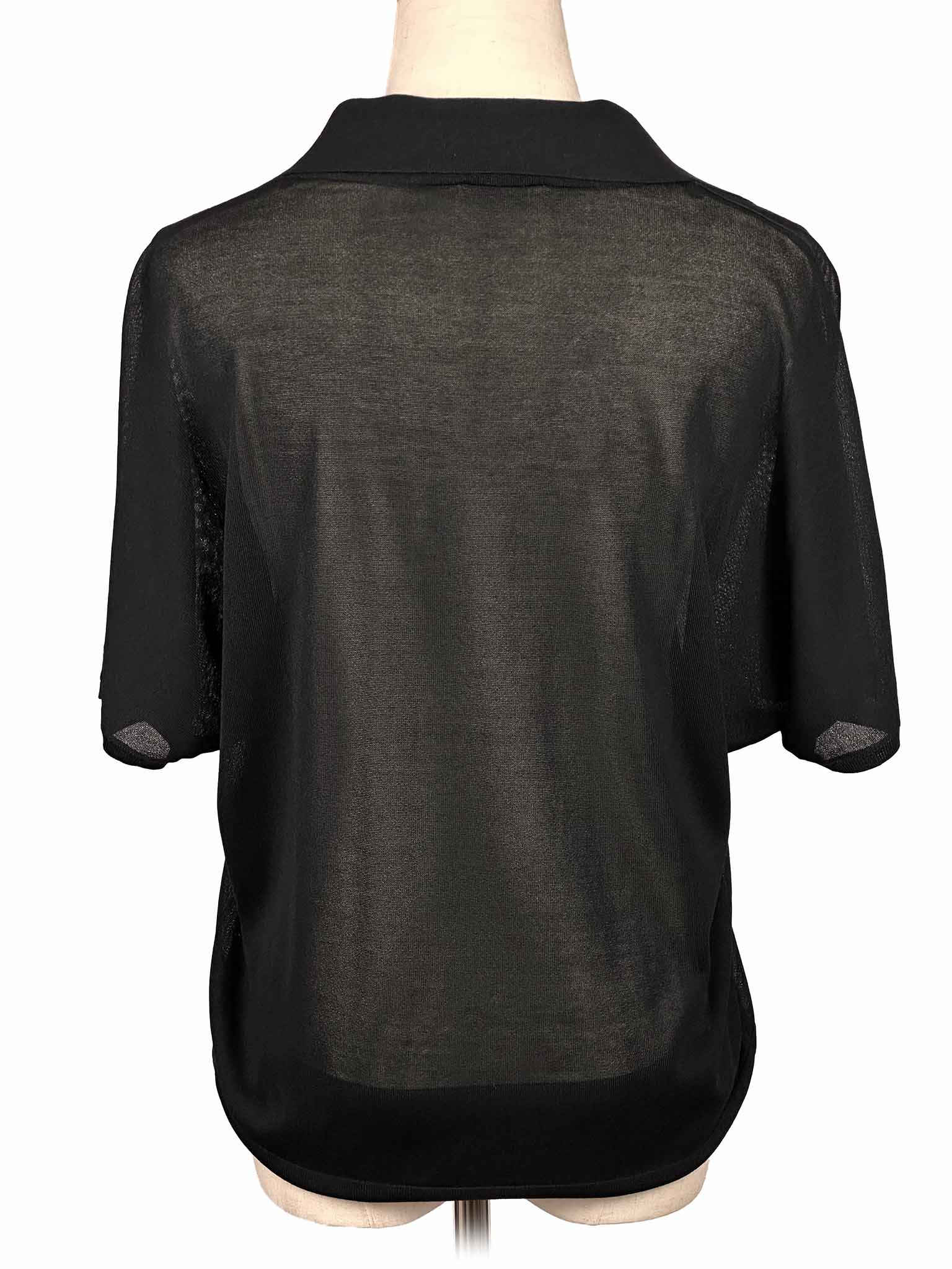 COS black blouse on a mannequin with a white background