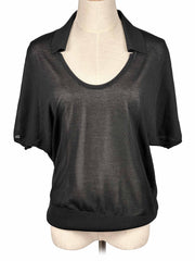 COS black blouse on a mannequin with a white background