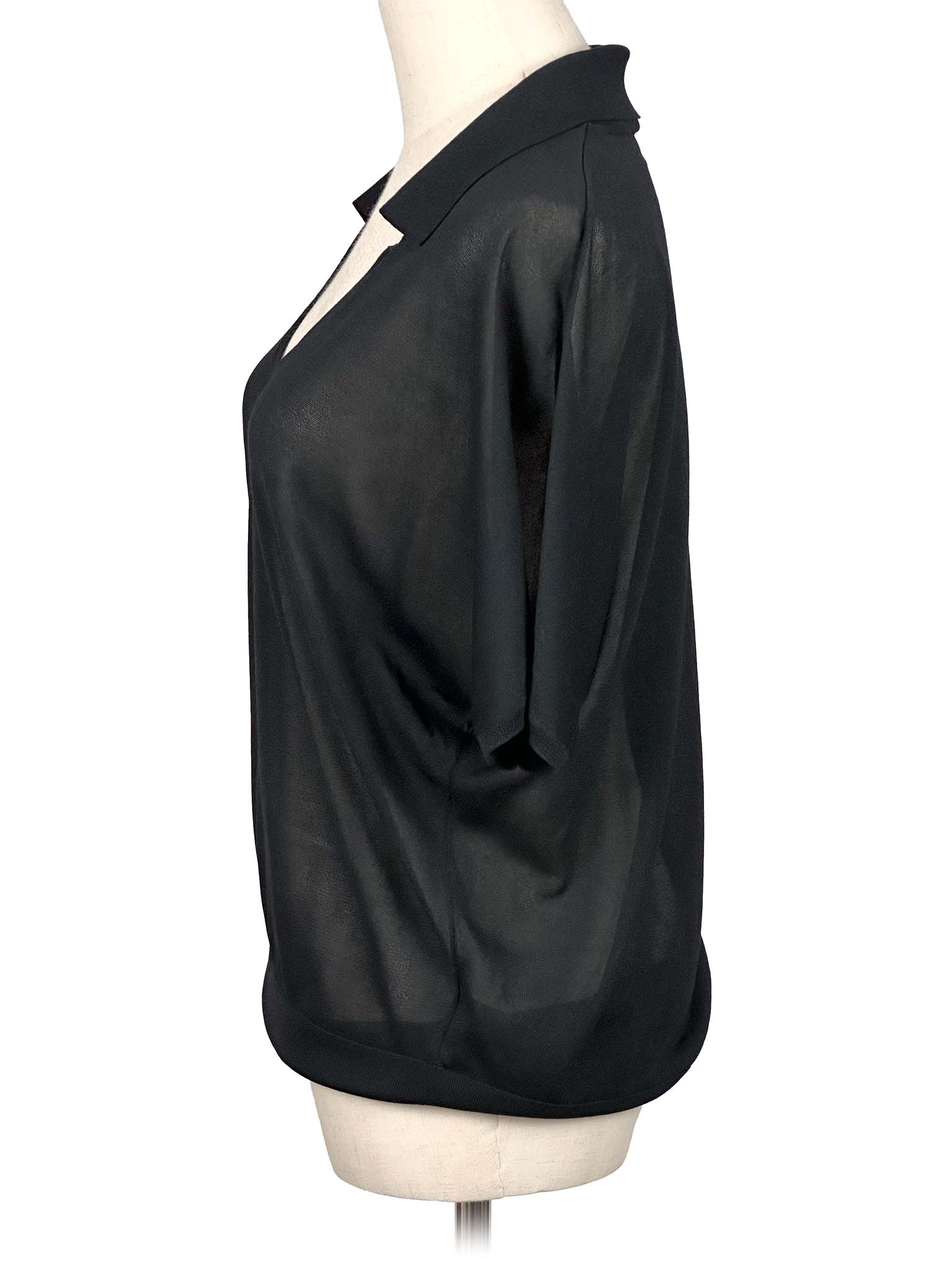 COS black blouse on a mannequin with a white background