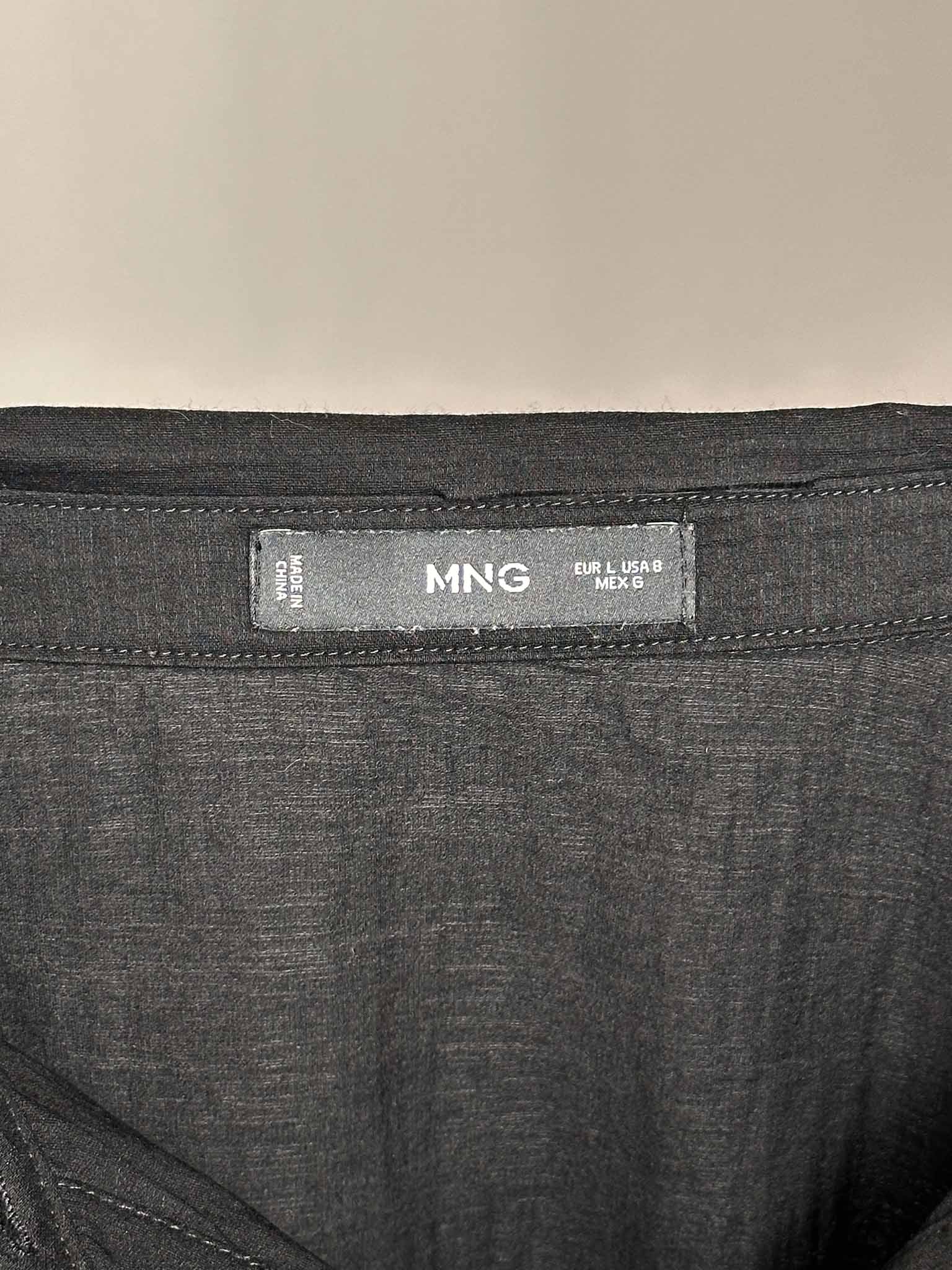 Close-up of a dark gray fabric with a 'MNG' label on a beige background
